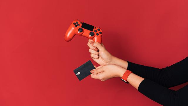 red video game controller, credit card, red background